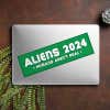Aliens - Humans Aren't Real Bumper Sticker on a closed laptop