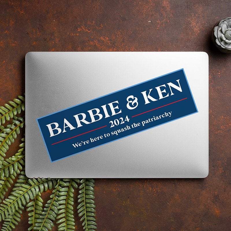 Barbie and Ken bumper sticker on a closed laptop