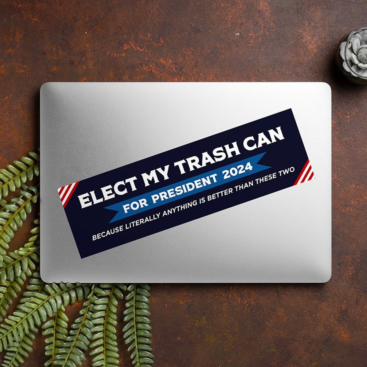 Elect My Trash Can Bumper Sticker on a closed laptop