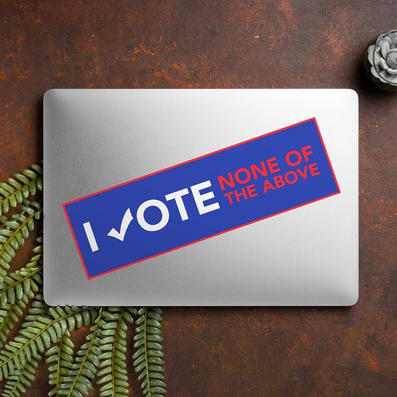 None of the Above Political Bumper Sticker on a closed laptop