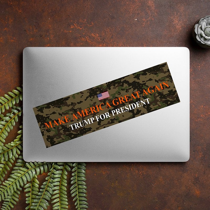 Camo MAGA Bumper Sticker on a closed laptop