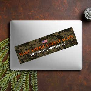 Camo MAGA Bumper Sticker on a closed laptop