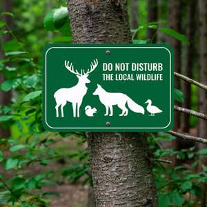 A Wildlife Conservation Aluminum Sign Mounted on a Tree