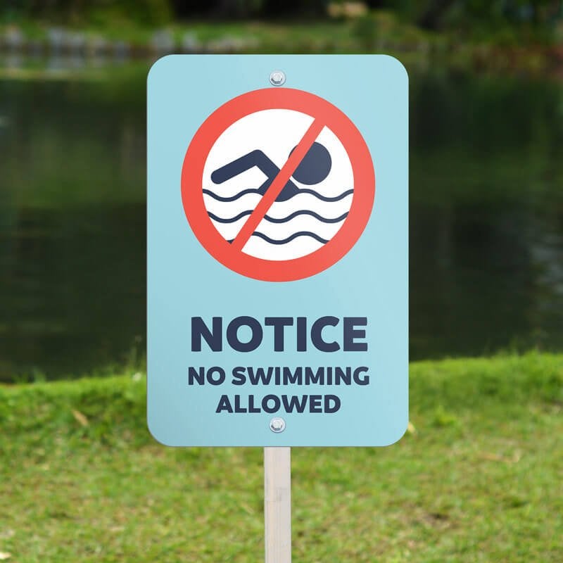An Aluminum Sign Notice for a No Swimming Area