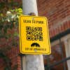 A Scan-to-Park QR Card on an Aluminum Sign Mounted to a Tree