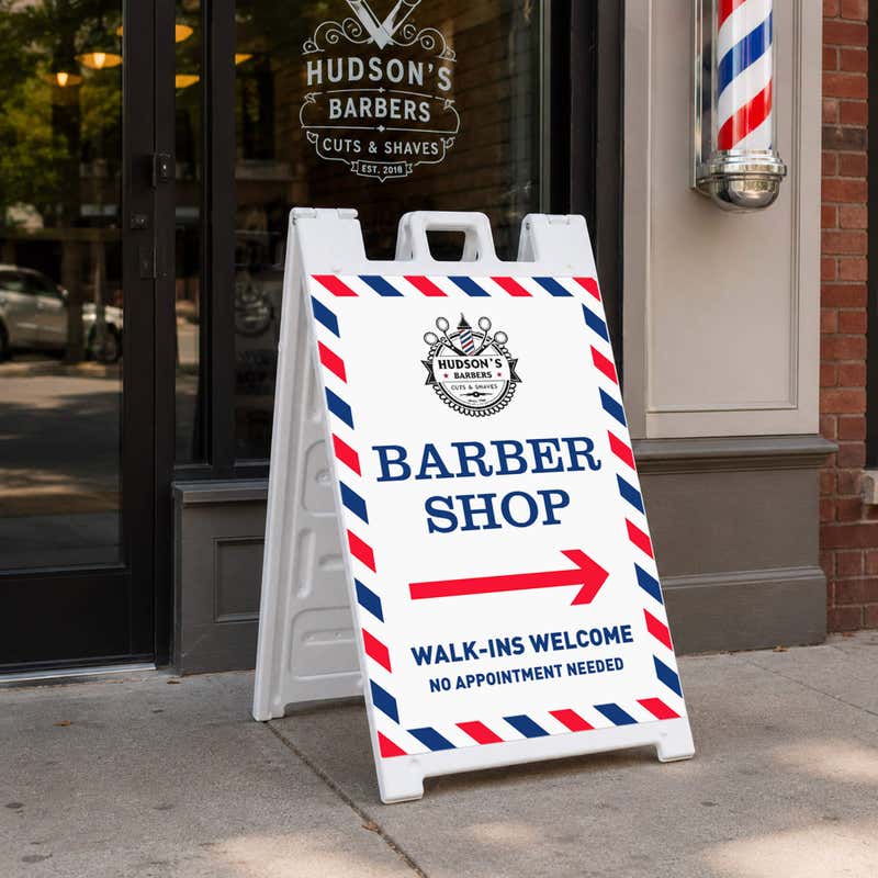 Barber shop A-frame sidewalk sign displayed in front of a shop