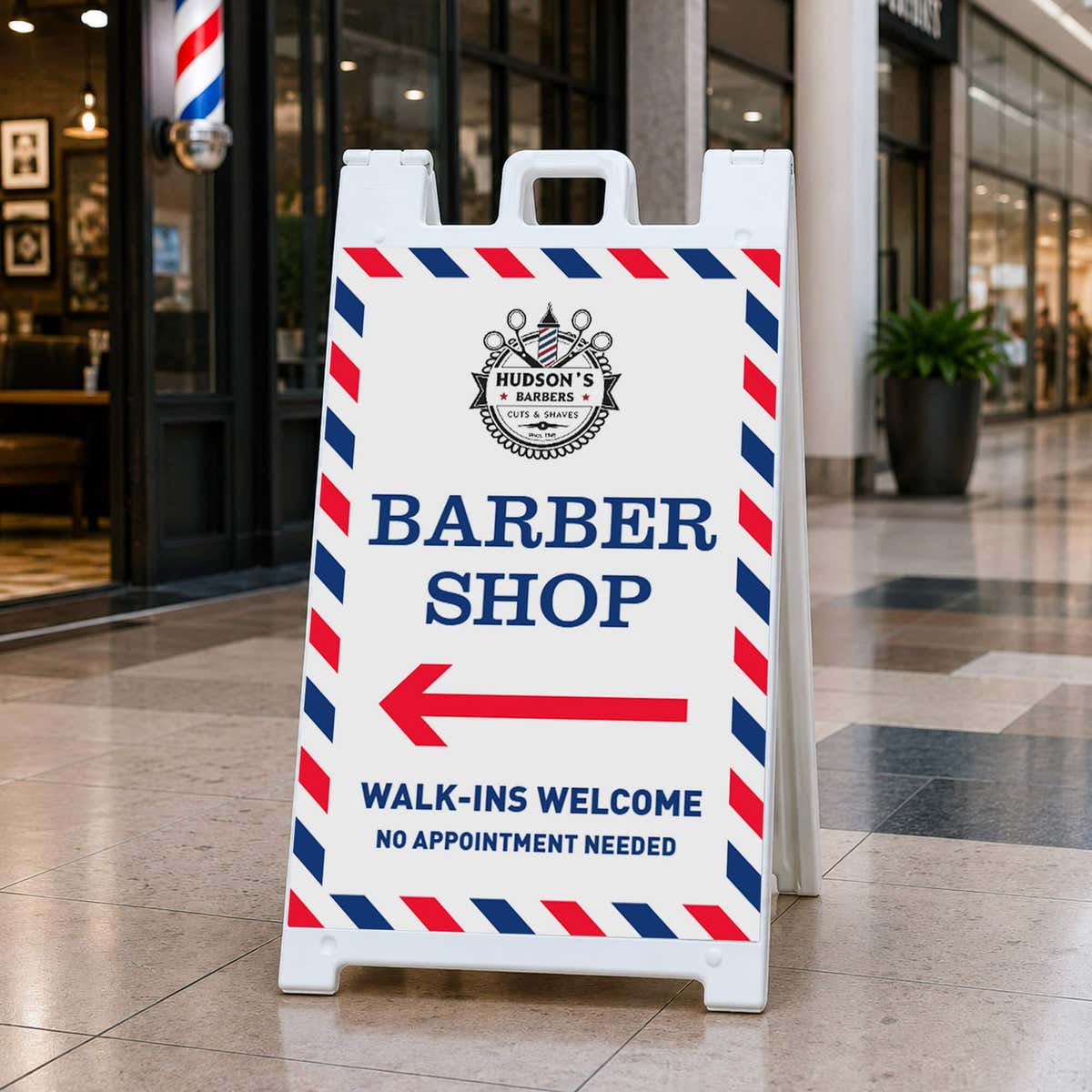 Barber shop A-frame sidewalk sign displayed in front of a shop