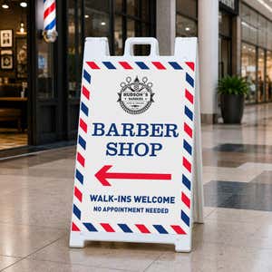 Barber shop A-frame sidewalk sign displayed in front of a shop