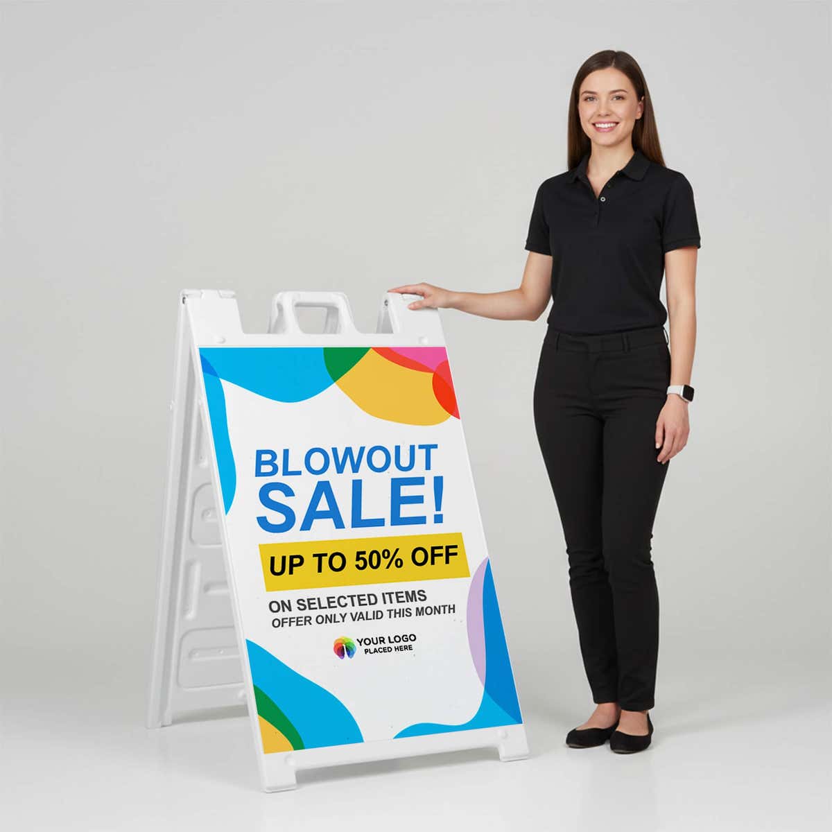 Woman standing beside a blowout sale A-frame sign for scale