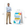 Blowout sale A-frame sign shown with size dimensions beside a man