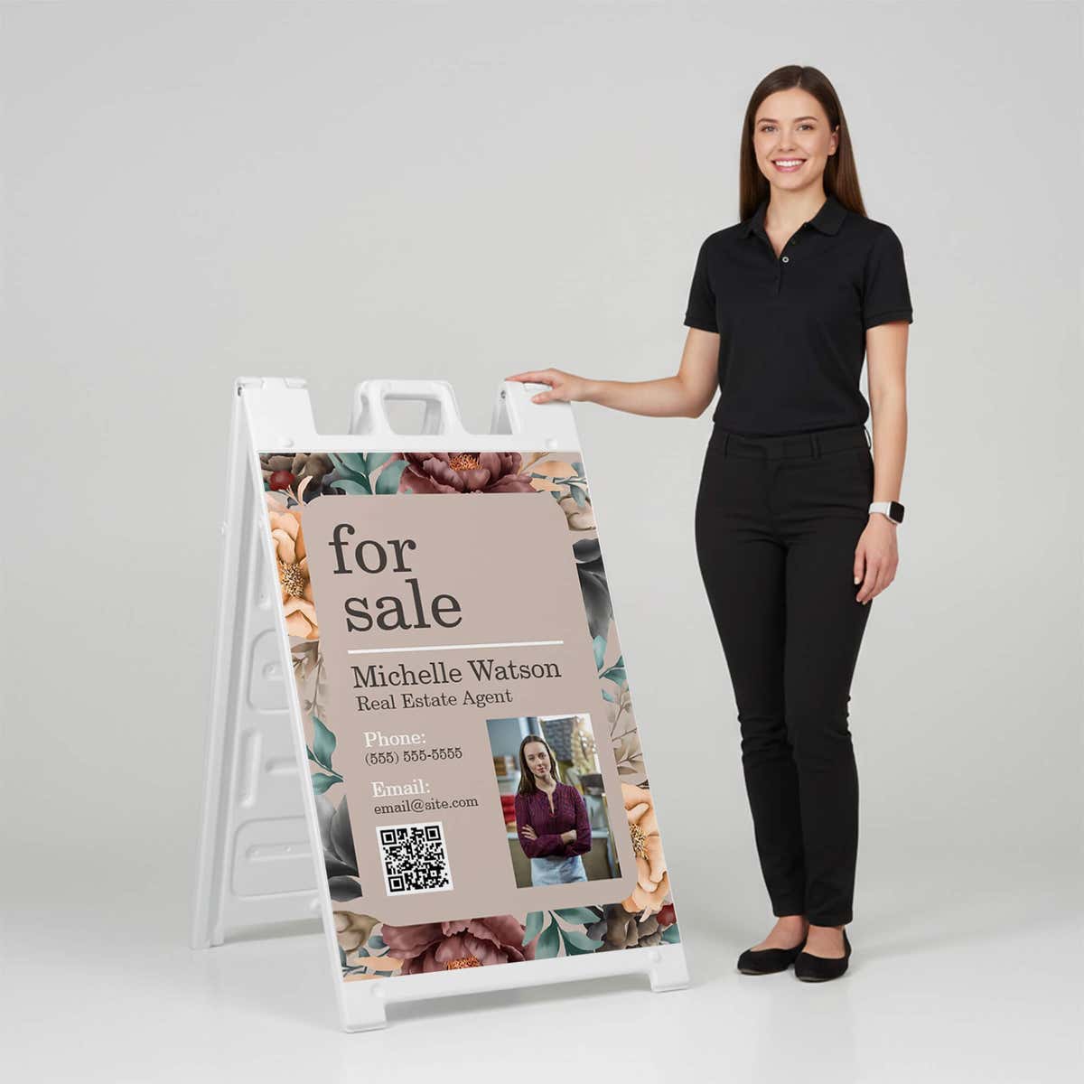 Woman standing beside a floral for sale A-frame sign for scale