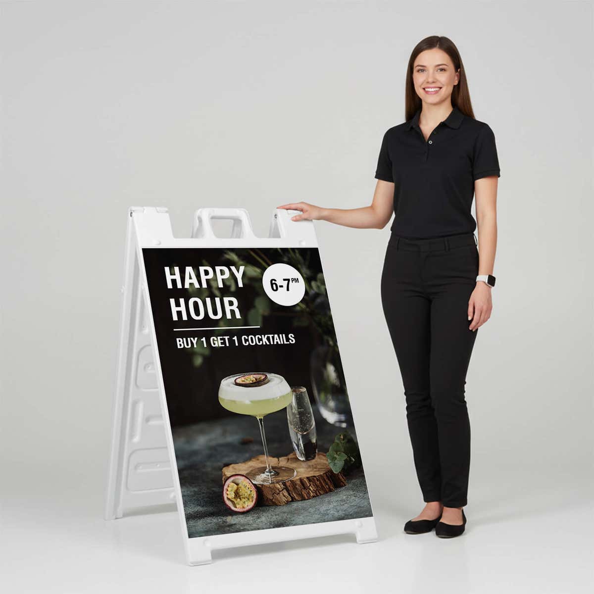 Woman standing beside a happy hour A-frame sign for scale