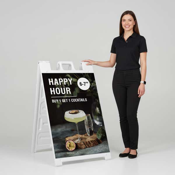 Woman standing beside a happy hour A-frame sign for scale