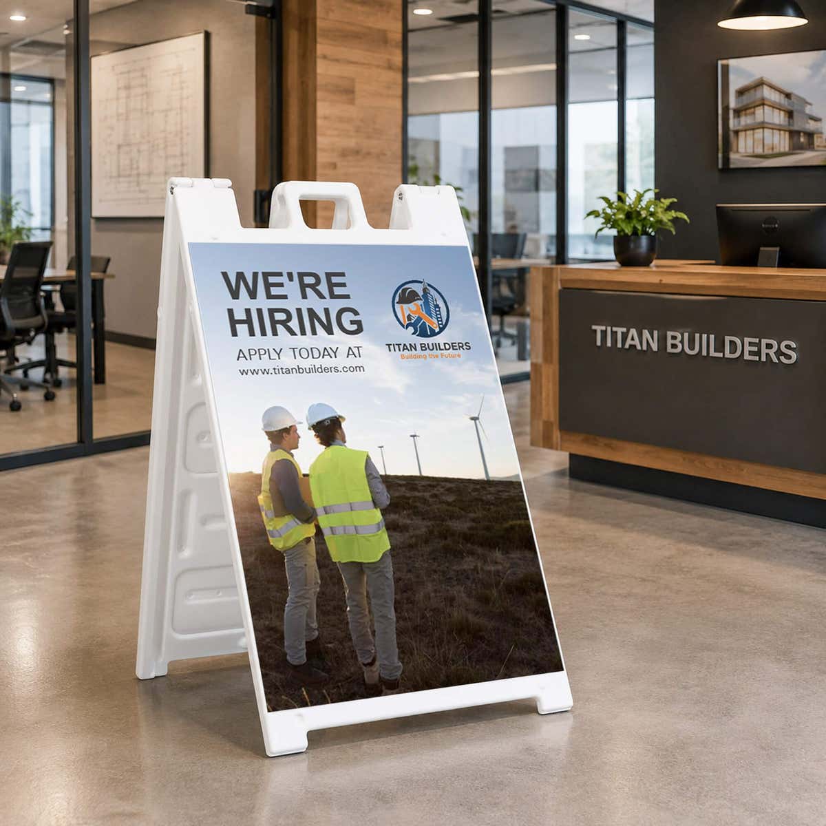 Construction now hiring A-frame sign displayed in an office lobby