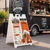 Restaurant menu A-frame sign set up beside a food truck