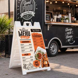 Restaurant menu A-frame sign set up beside a food truck