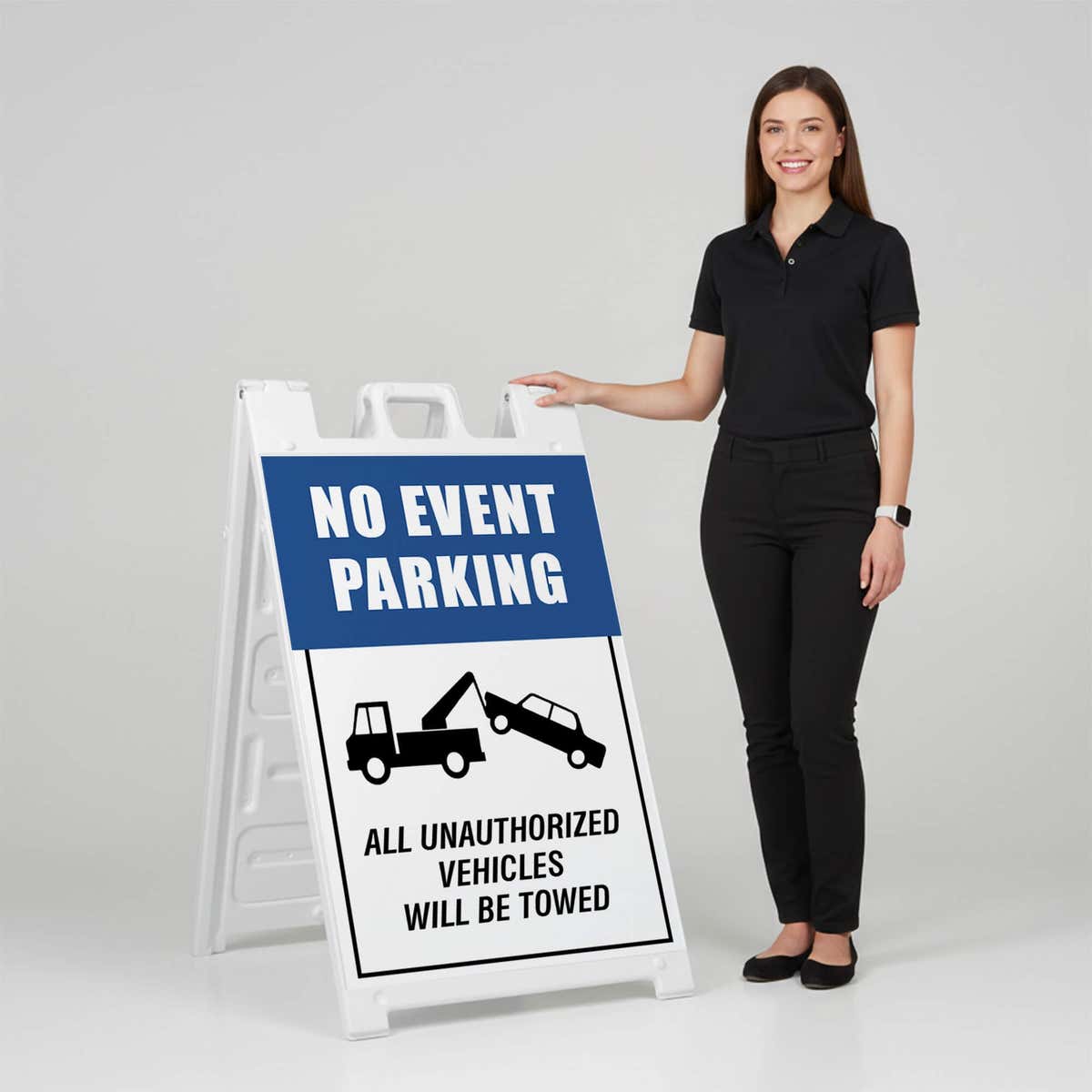 Woman standing beside a no event parking A-frame sign for scale