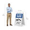 No event parking A-frame sign shown with size dimensions beside a man