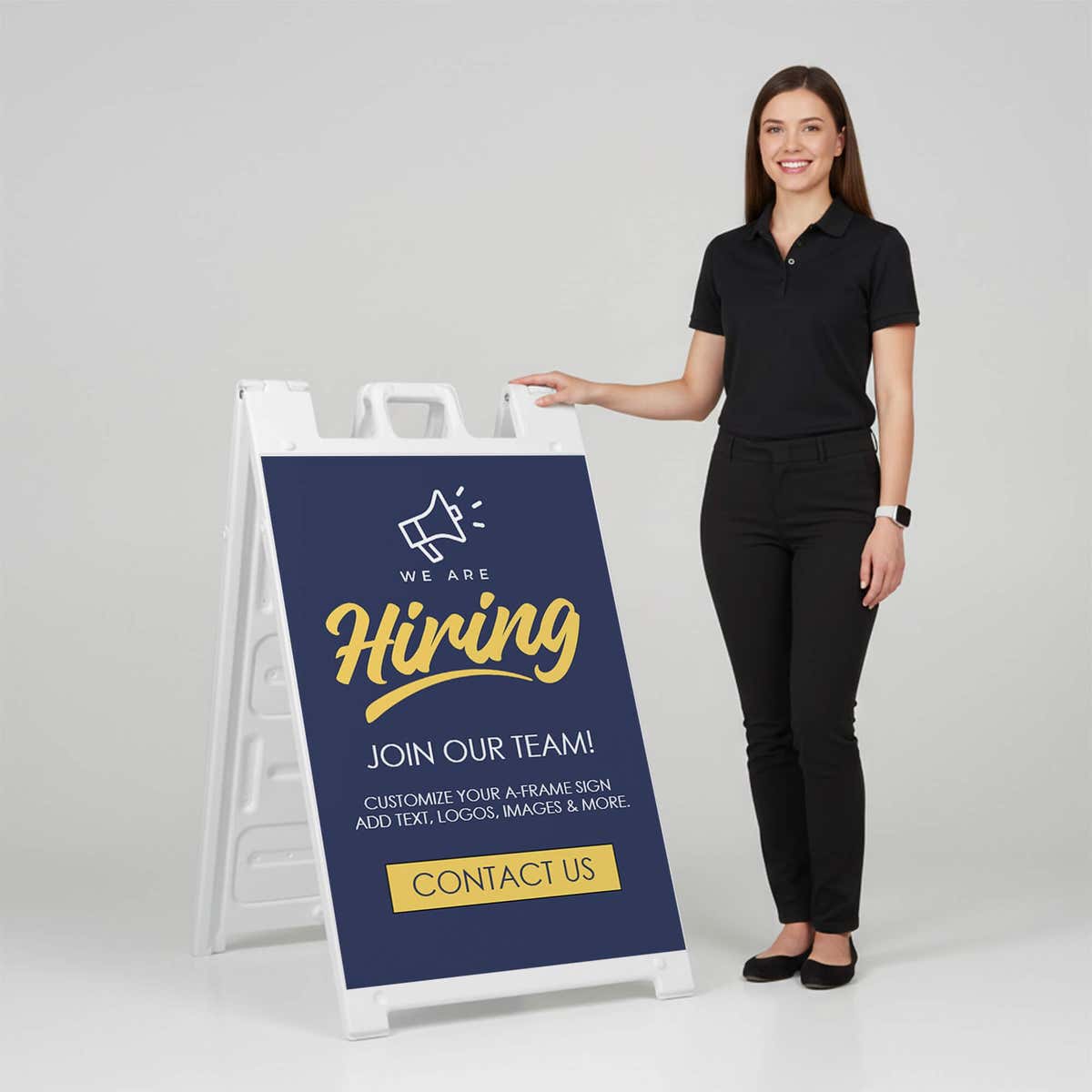 Woman standing beside a blue now hiring A-frame sign for scale