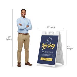 Blue now hiring A-frame sign shown with size dimensions beside a man