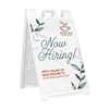 Floral now hiring A-frame sidewalk sign in white plastic frame, angled view