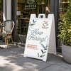 Floral now hiring A-frame sidewalk sign displayed in front of a store