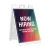 Rainbow now hiring A-frame sidewalk sign in white plastic frame, angled view