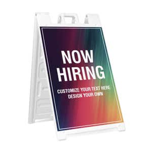 Rainbow now hiring A-frame sidewalk sign in white plastic frame, angled view