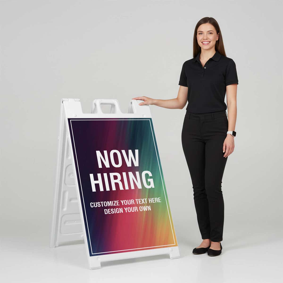 Woman standing beside a rainbow now hiring A-frame sign for scale