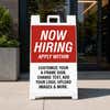 Red now hiring A-frame sidewalk sign displayed in front of a business