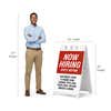 Red now hiring A-frame sign shown with size dimensions beside a man