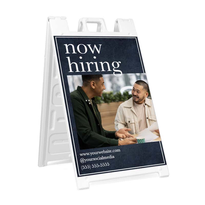 Serif now hiring A-frame sidewalk sign in white plastic frame, angled view