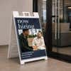 Serif now hiring A-frame sign on a college campus walkway