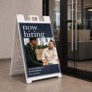 Serif now hiring A-frame sign on a college campus walkway