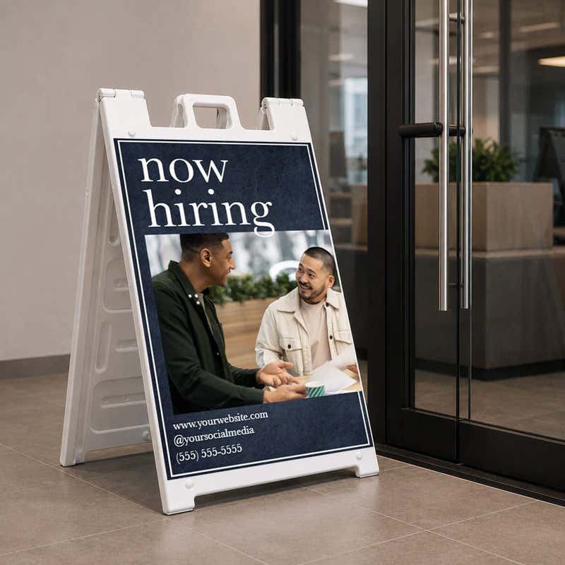 Serif now hiring A-frame sign on a college campus walkway