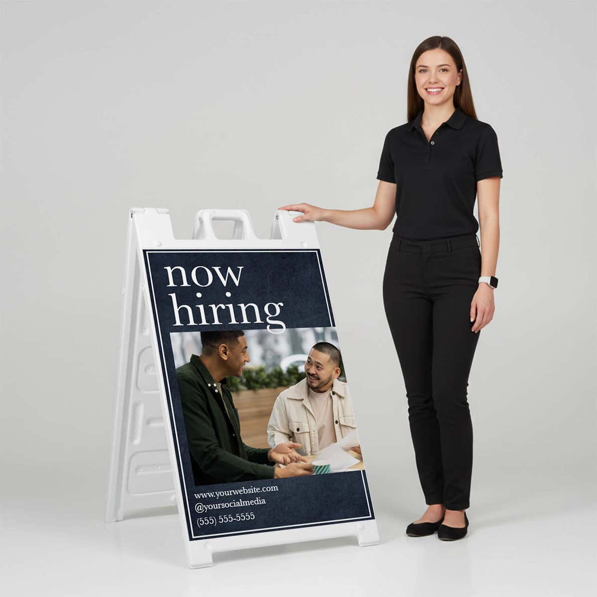 Woman standing beside a serif now hiring A-frame sign for scale