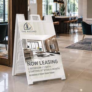 Now leasing A-frame sign at an apartment leasing office