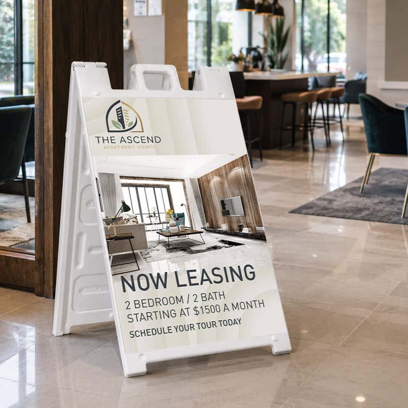 Now leasing A-frame sign at an apartment leasing office