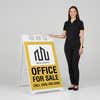 Woman standing beside a office for sale A-frame sign for scale