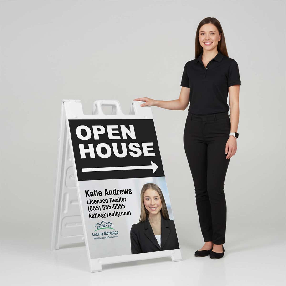 Woman standing beside a black open house A-frame sign for scale