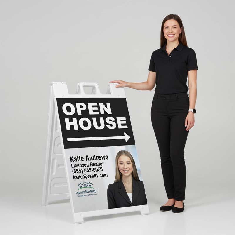 Woman standing beside a black open house A-frame sign for scale