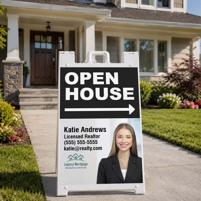 Black open house A-frame sign standing on a sidewalk