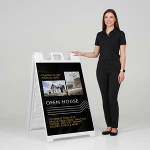 Woman standing beside a modern open house A-frame sign for scale