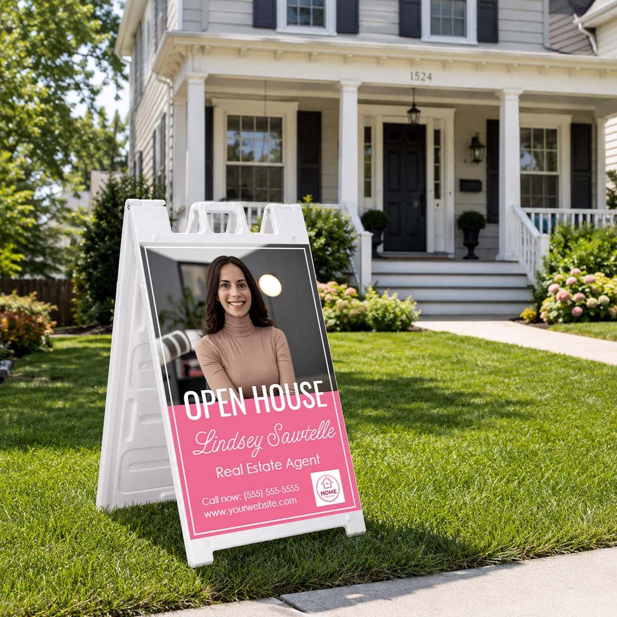Pink open house real estate A-frame sign in a home front yard