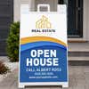 Wave open house real estate A-frame sign on a home front porch