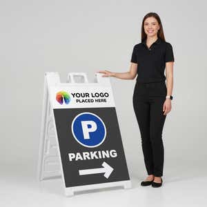 Woman standing beside a logo parking A-frame sign for scale