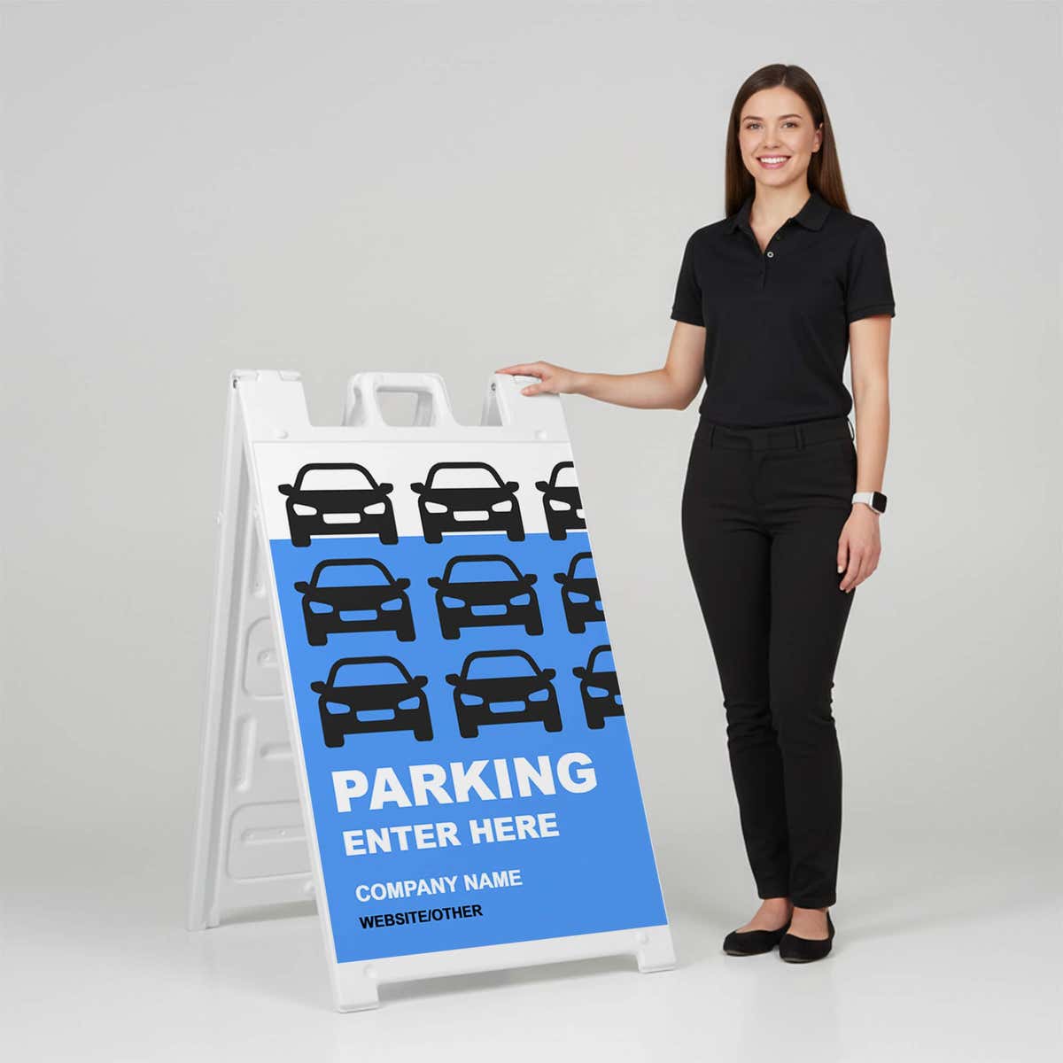 Woman standing beside a custom Parking Enter Here A-frame sign for scale