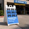 Parking Enter Here A-frame sign directing drivers at a street-facing entrance