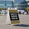 Shuttle service A-frame sign displayed in a parking lot