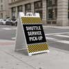 Shuttle service A-frame sign standing on a sidewalk